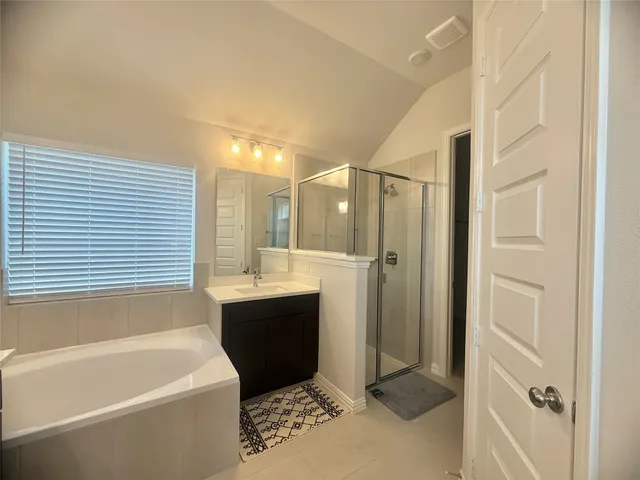 a bathroom with a bathtub a sink and a shower