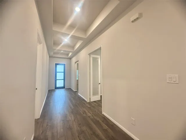 a view of hallway with wooden floor