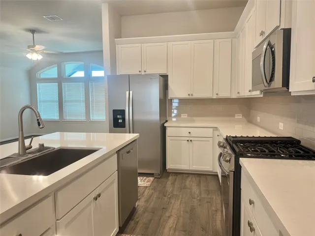 a kitchen that has a sink and a stove