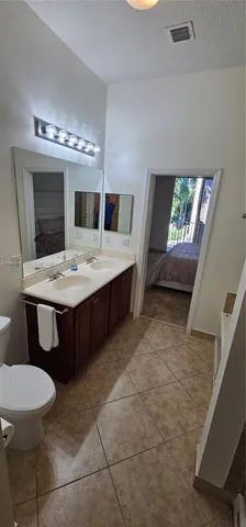a bathroom with a sink a toilet and mirror