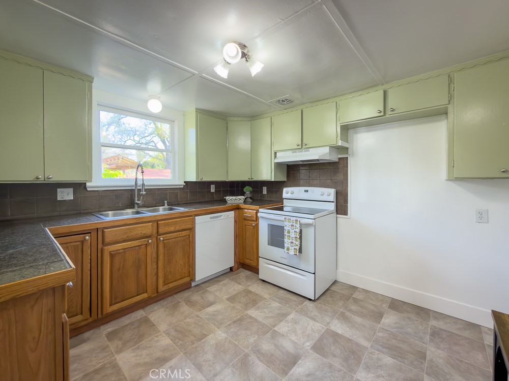 243 West 3rd Avenue Chico, CA 95926 - Photo 14 of 41 a kitchen with granite countertop a sink cabinets stainless steel appliances and a window