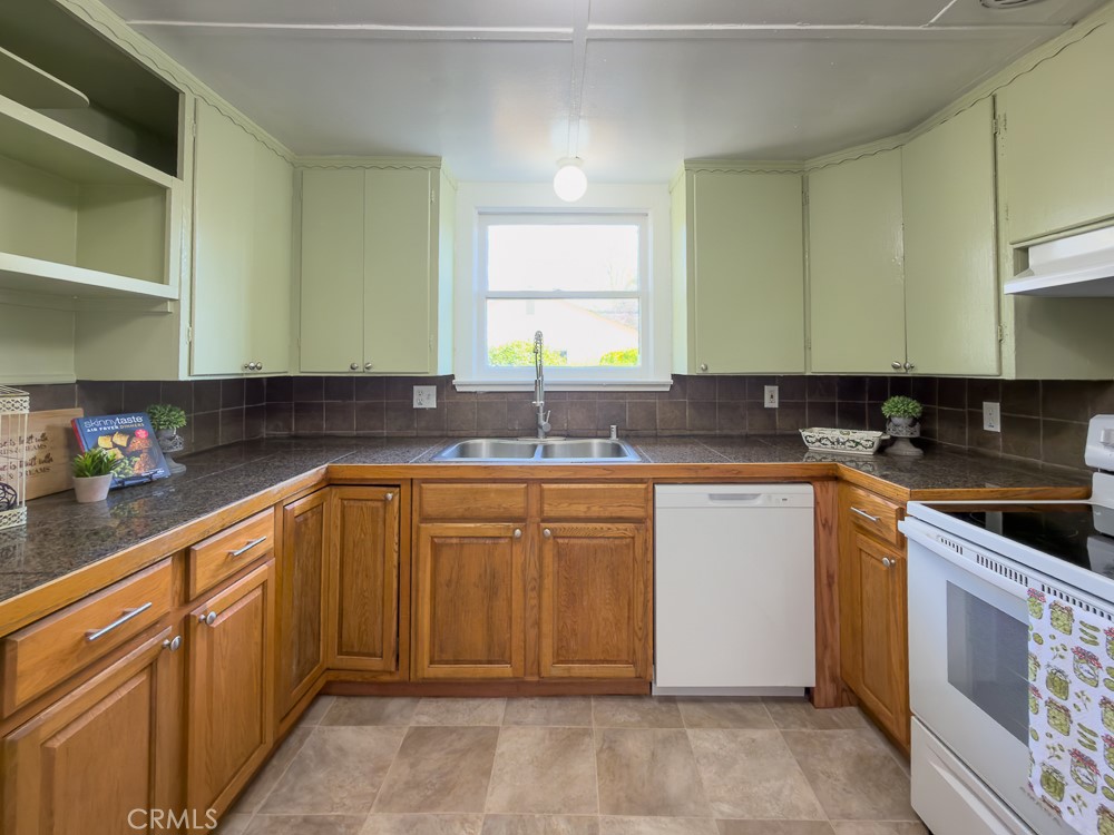 243 West 3rd Avenue Chico, CA 95926 - Photo 16 of 41 a kitchen with granite countertop a sink and white cabinets