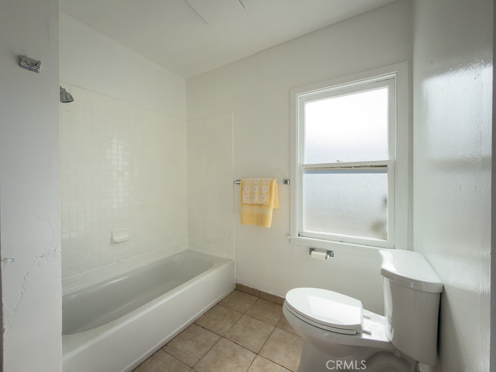 243 West 3rd Avenue Chico, CA 95926 - Photo 26 of 41 a bathroom with a granite countertop toilet a sink and bathtub