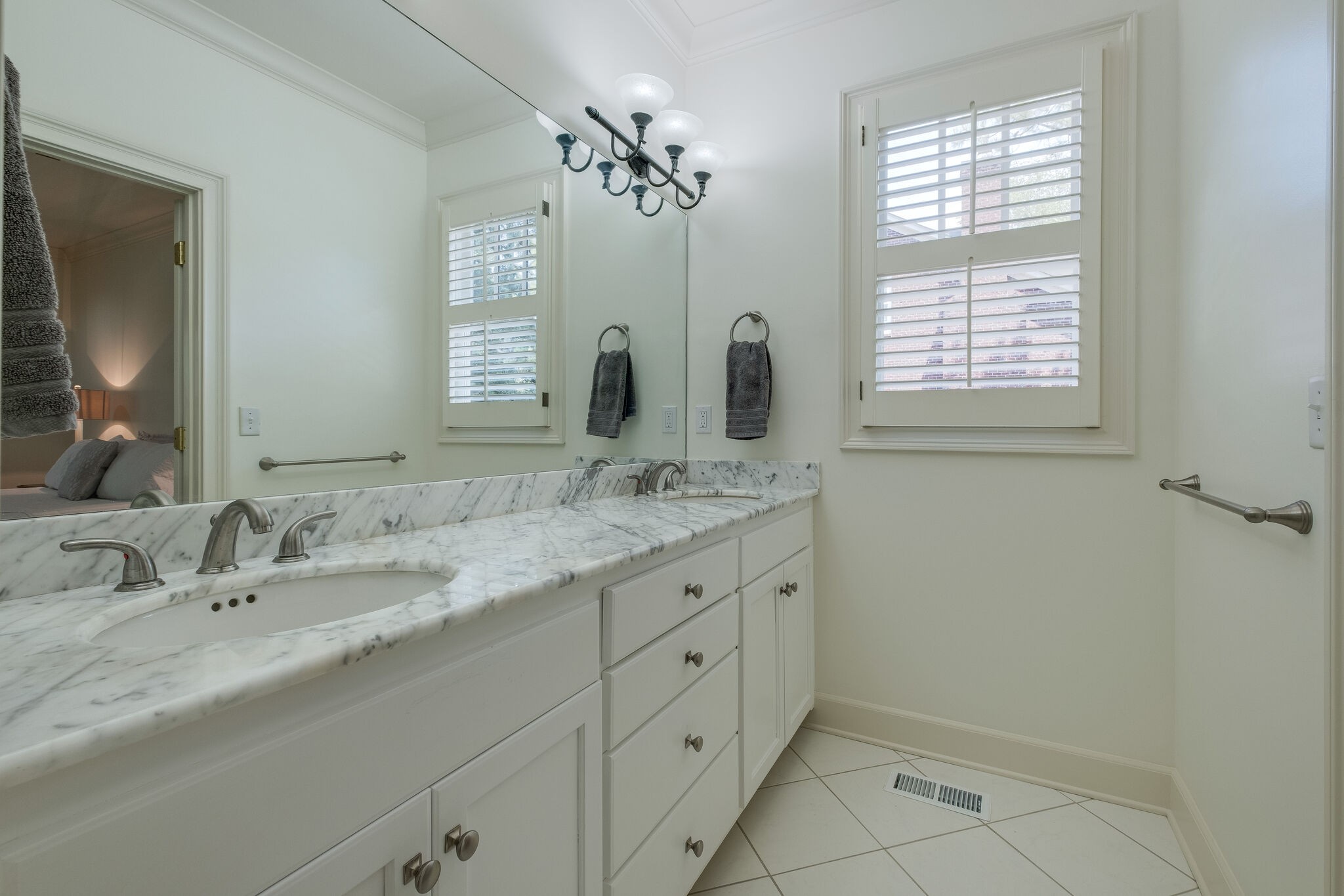 4412 Estes Road Nashville, TN 37215 - Photo 22 of 35 a bathroom with double sink and a mirror