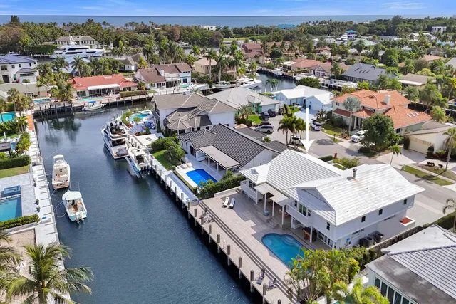 an aerial view of a house with a yard and fountain