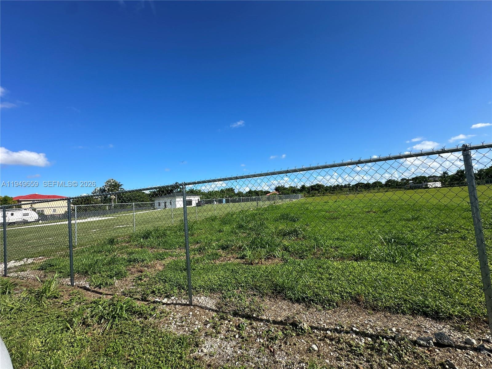19690 Southwest 206th Street Miami, FL 33187 - Photo 4 of 24 a view of a green field with an outdoor space