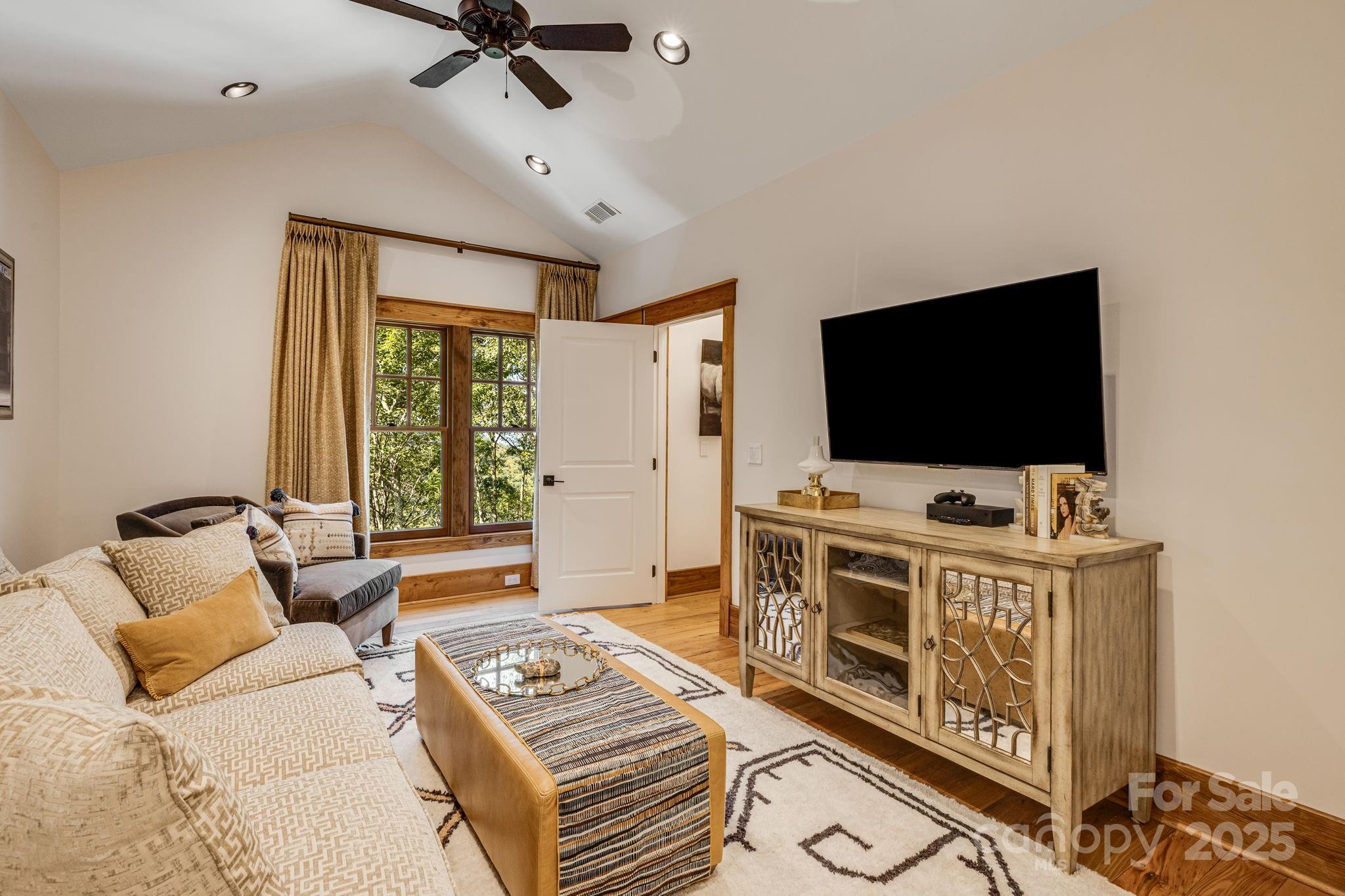 85 Back Bone Way, Unit 200 Sylva, NC 28779 - Photo 25 of 48 a living room with furniture and a flat screen tv