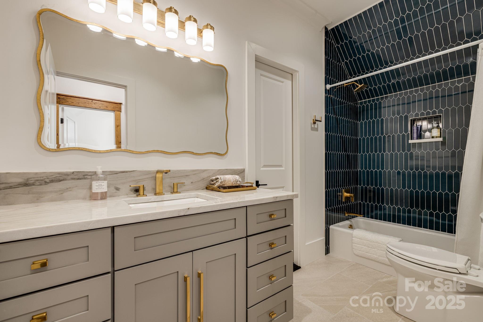 85 Back Bone Way, Unit 200 Sylva, NC 28779 - Photo 27 of 48 a bathroom with a sink a vanity and mirror
