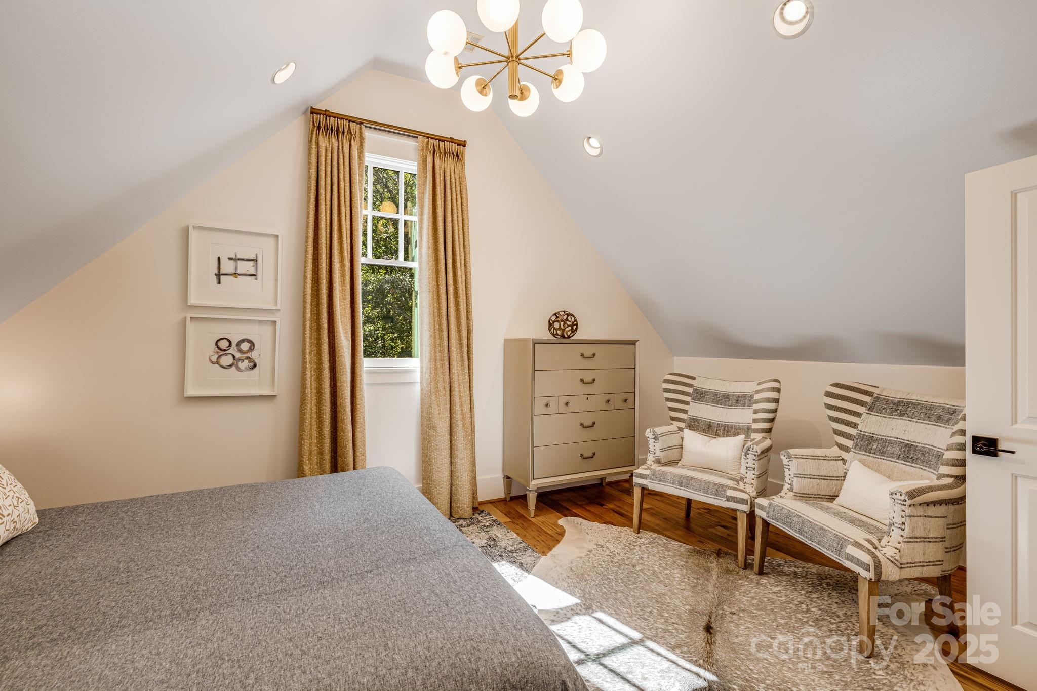 85 Back Bone Way, Unit 200 Sylva, NC 28779 - Photo 28 of 48 a bedroom with a bed and a chandelier