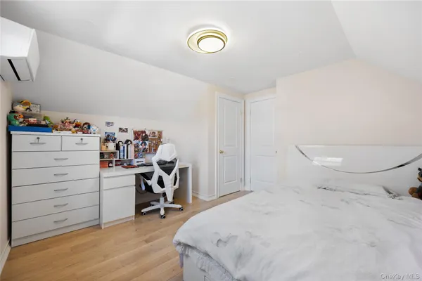 a bedroom with a bed and a chair in it