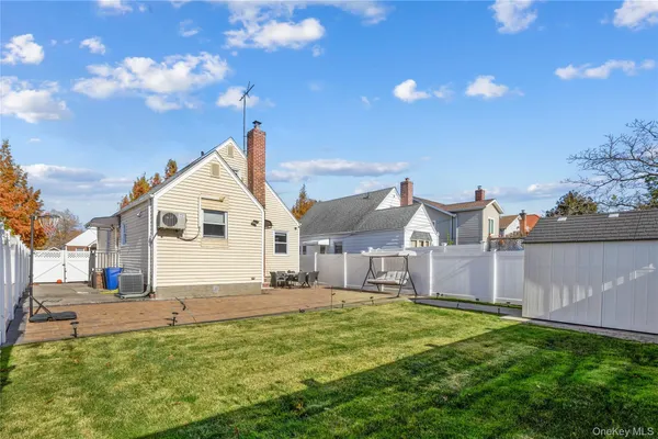 a view of a white house with a yard