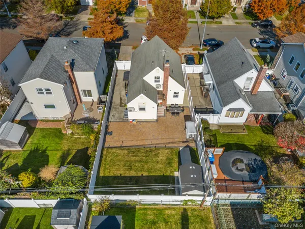 an aerial view of residential houses with outdoor space and swimming pool