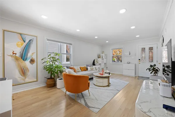 a living room with furniture potted plant and a table