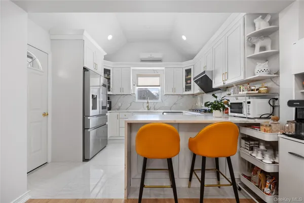 a kitchen with stainless steel appliances granite countertop a sink cabinets and window