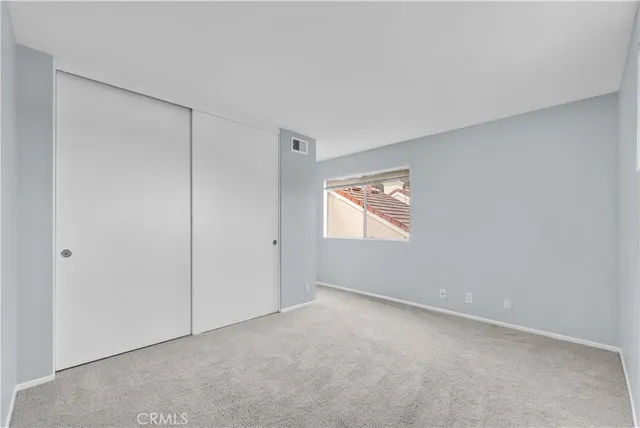 a view of an empty room and a window