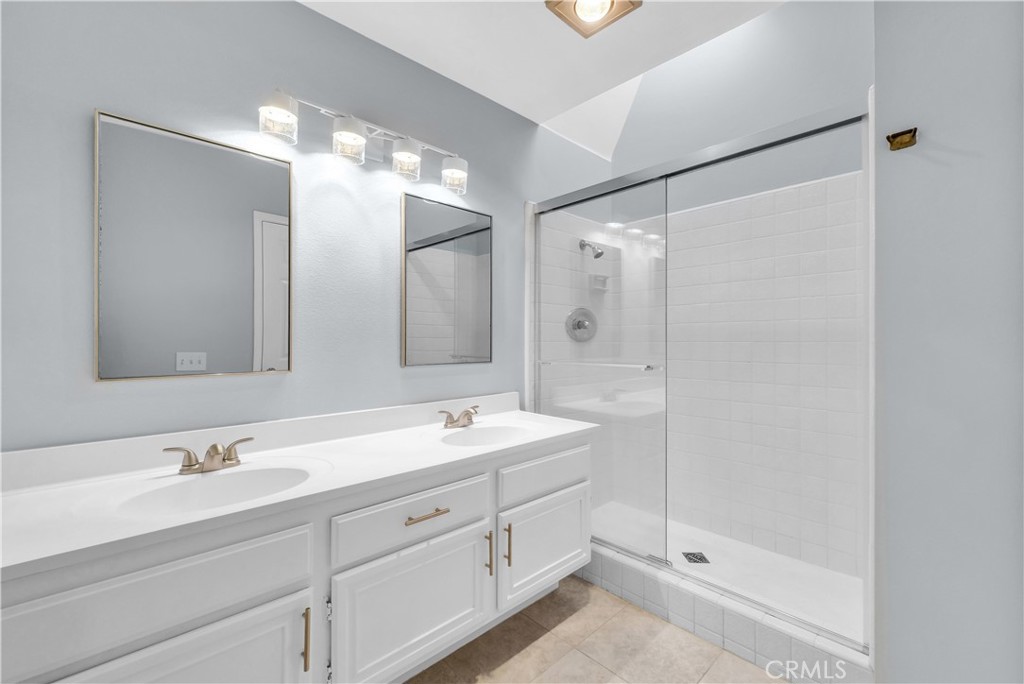 4 Wellesley Irvine, CA 92612 - Photo 20 of 24 a bathroom with a double vanity sink mirror and shower