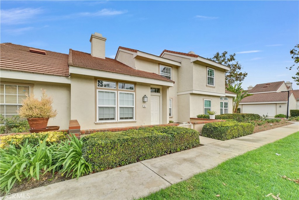 4 Wellesley Irvine, CA 92612 - Photo 2 of 24 a front view of a house with a garden