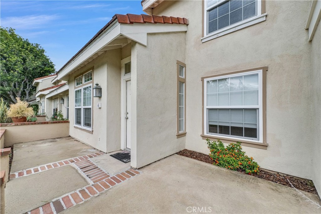 4 Wellesley Irvine, CA 92612 - Photo 4 of 24 a front view of a house with a yard