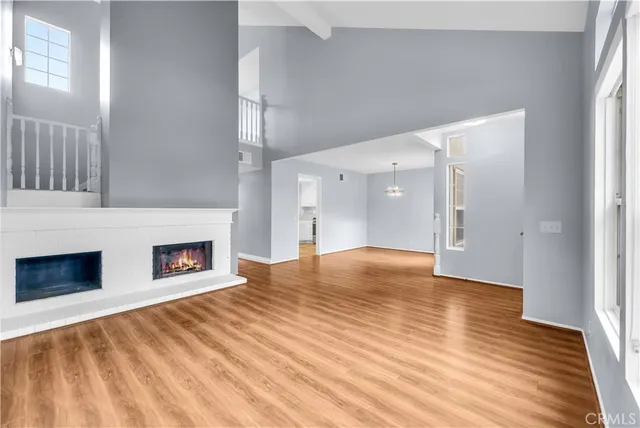 a view of empty room with wooden floor and fireplace