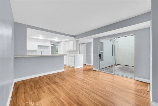 a view of an empty room with cabinet and a window