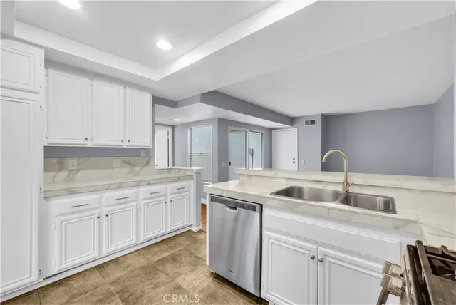 a kitchen with sink and cabinets