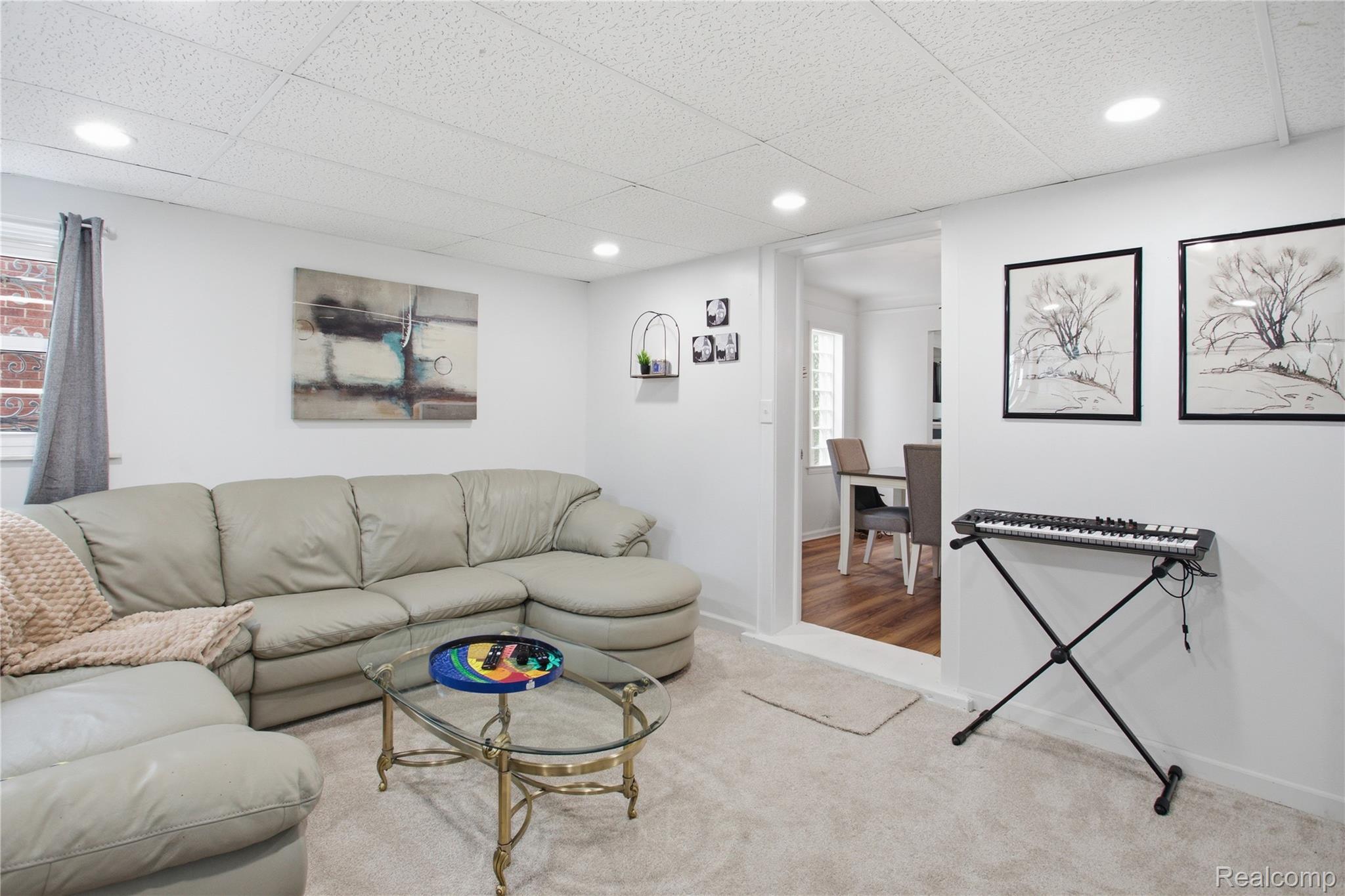20417 Sheffield Road Detroit, MI 48221 - Photo 17 of 39 Recessed lighting illuminates the carpeted living area with white walls