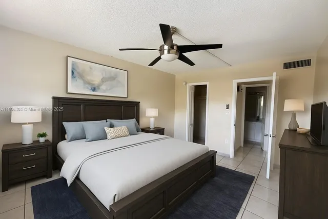 a bedroom with a bed and a view of kitchen