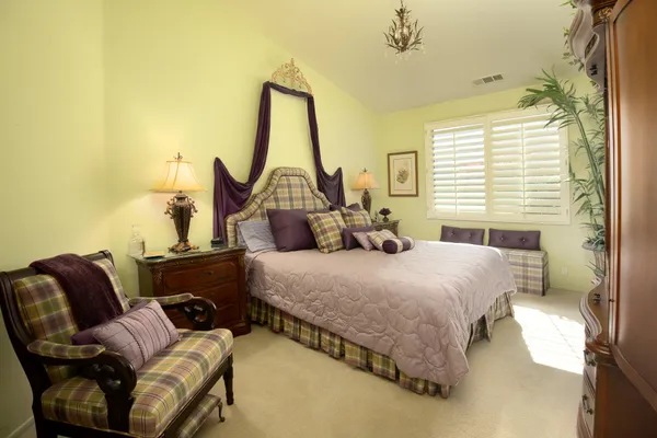 a bedroom with a bed window and couch