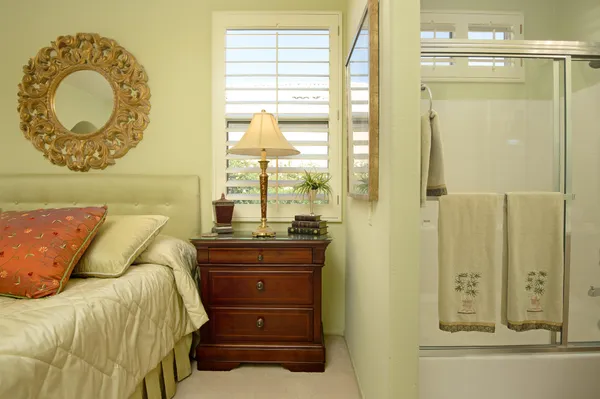 a bedroom with a bed and a mirror