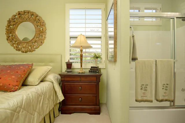 a bedroom with a bed and a mirror