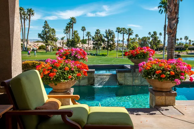 a view of a chairs and table in backyard of the house
