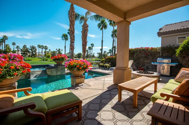 a view of a chairs and table in patio with a fire pit