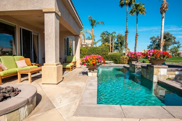 a view of a patio with table and chairs potted plants