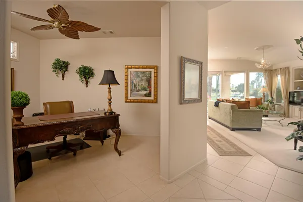 a view of a livingroom with furniture and a ceiling fan