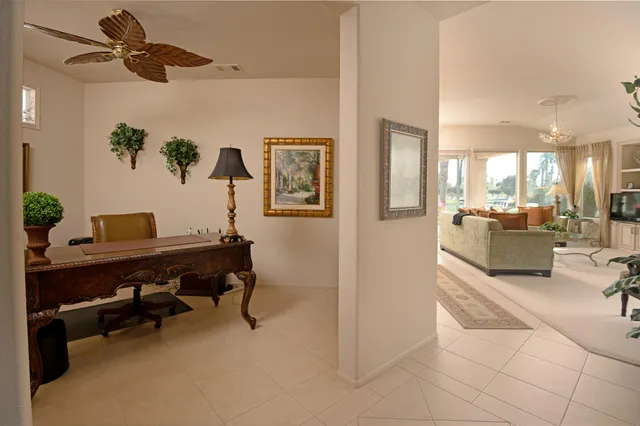 a view of a livingroom with furniture and a ceiling fan