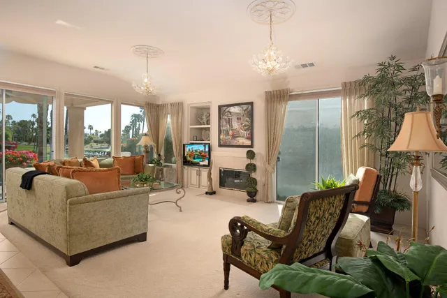 a living room with furniture and a chandelier