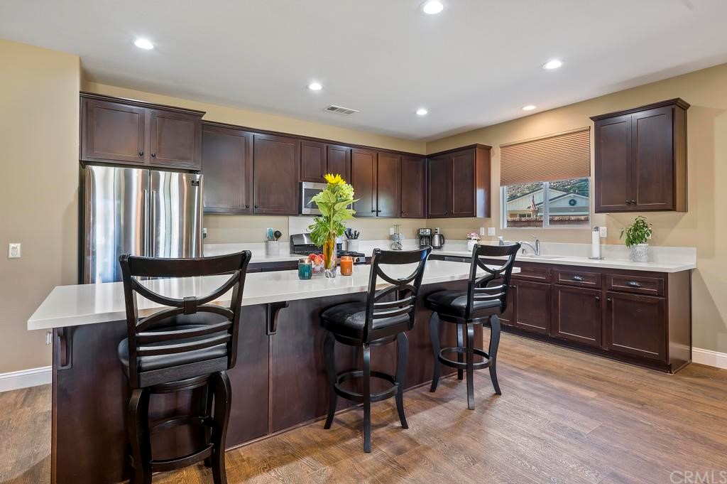 25218 Wild View Road Menifee, CA 92584 - Photo 1 of 1 a kitchen with a dining table chairs and refrigerator