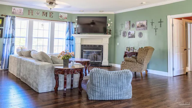 a living room with fireplace furniture and a wooden floor