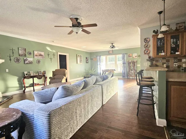 a view of a dining room with furniture and chandelier