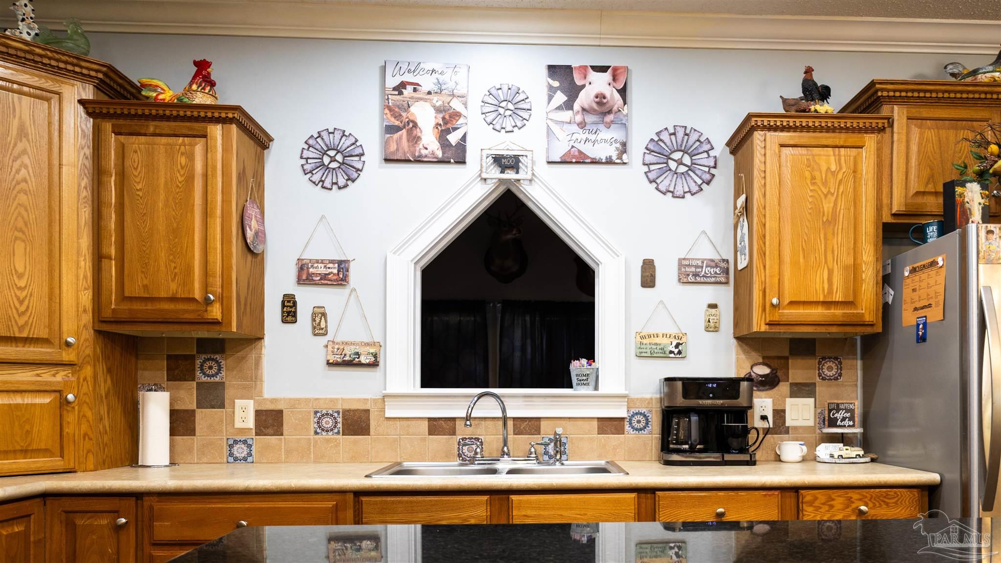1700 Prospect Road Coffeeville, AL 36524 - Photo 26 of 71 a kitchen with stainless steel appliances granite countertop a stove and cabinets
