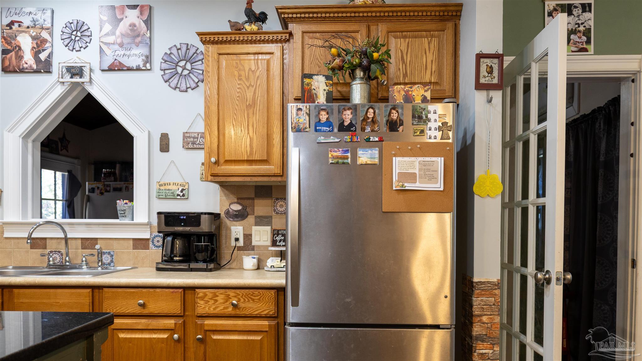 1700 Prospect Road Coffeeville, AL 36524 - Photo 27 of 71 a kitchen with stainless steel appliances granite countertop a refrigerator and a sink