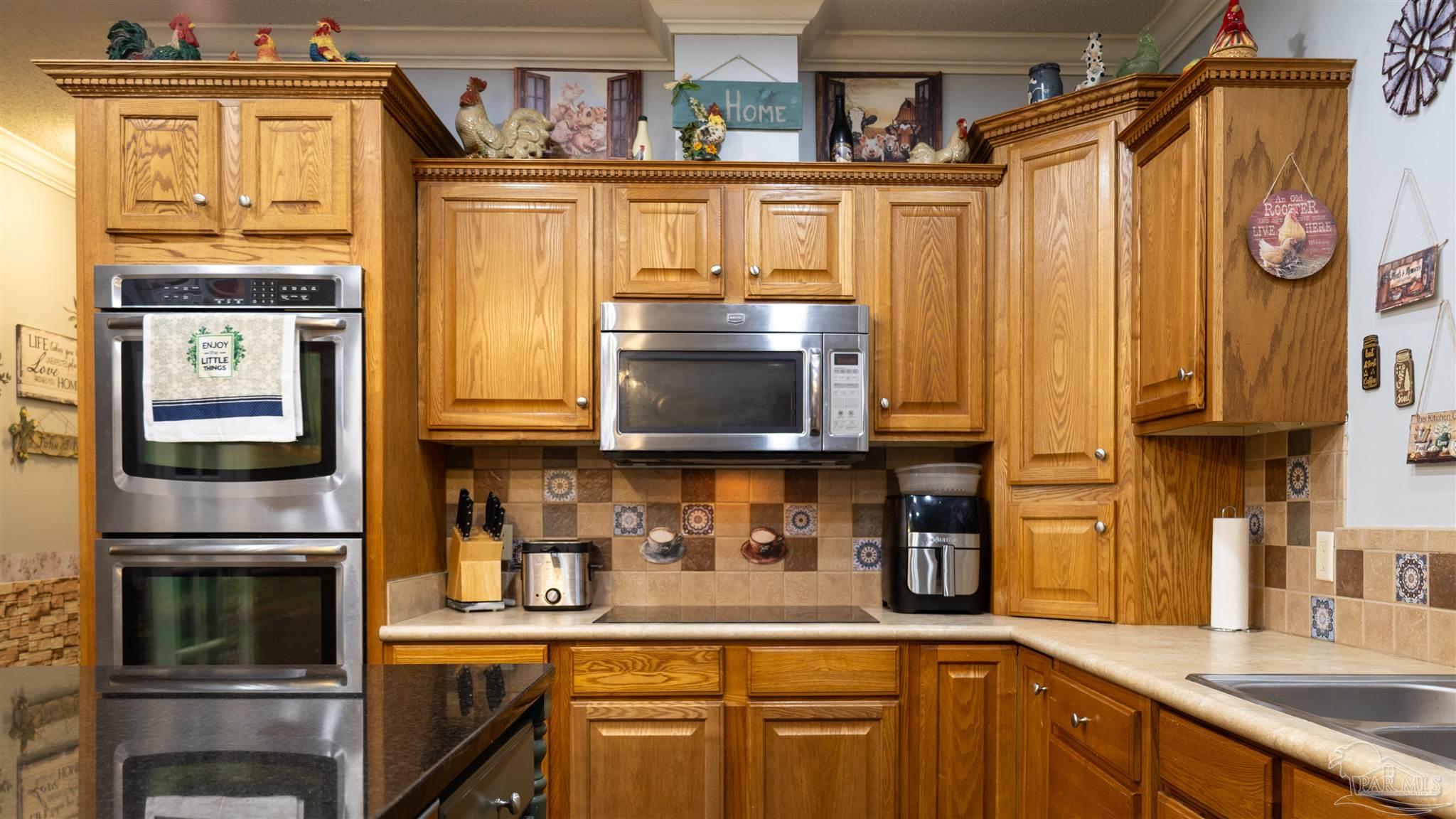 1700 Prospect Road Coffeeville, AL 36524 - Photo 28 of 71 a kitchen with stainless steel appliances granite countertop a refrigerator and a sink