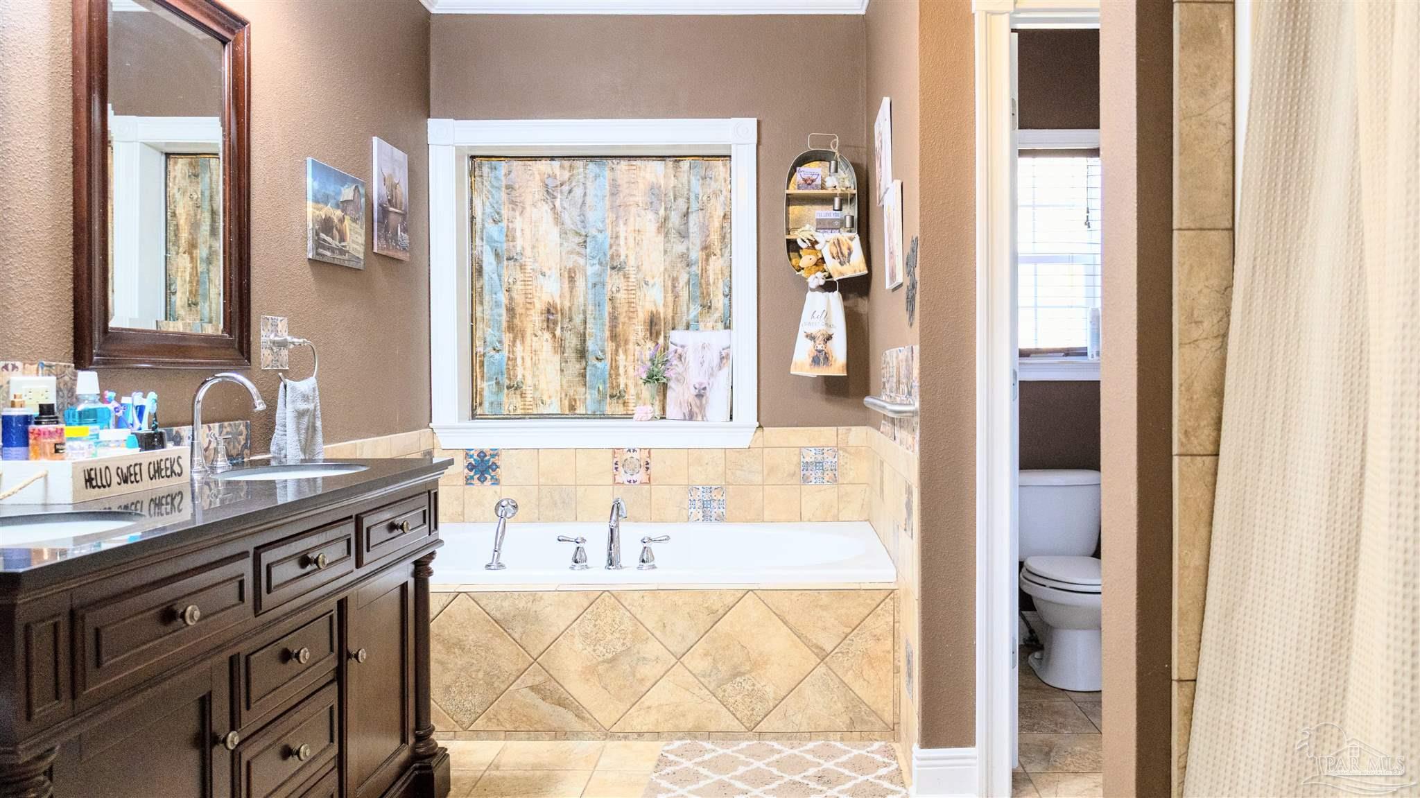 1700 Prospect Road Coffeeville, AL 36524 - Photo 40 of 71 a bathroom with a granite countertop sink and a mirror
