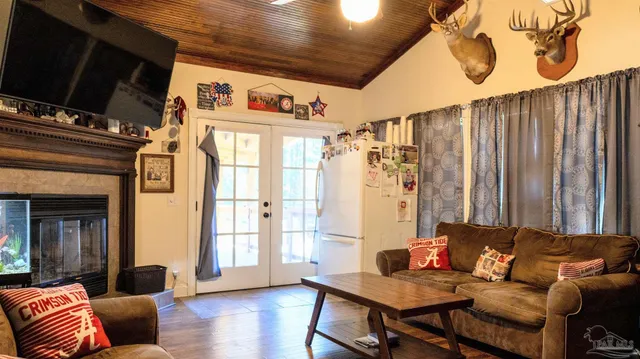 a living room with fireplace furniture and a flat screen tv