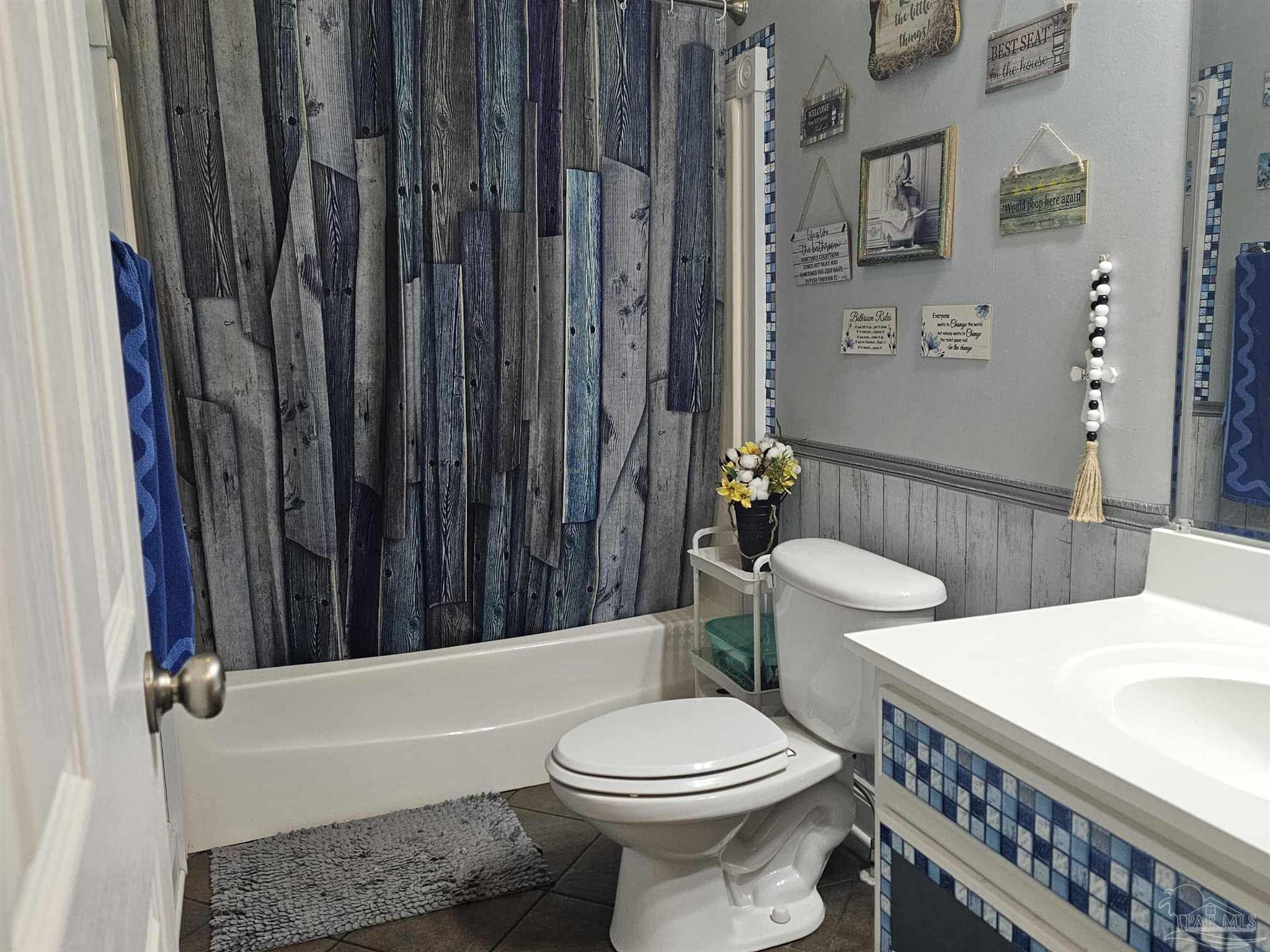 1700 Prospect Road Coffeeville, AL 36524 - Photo 42 of 71 a bathroom with a sink a toilet and shower curtain