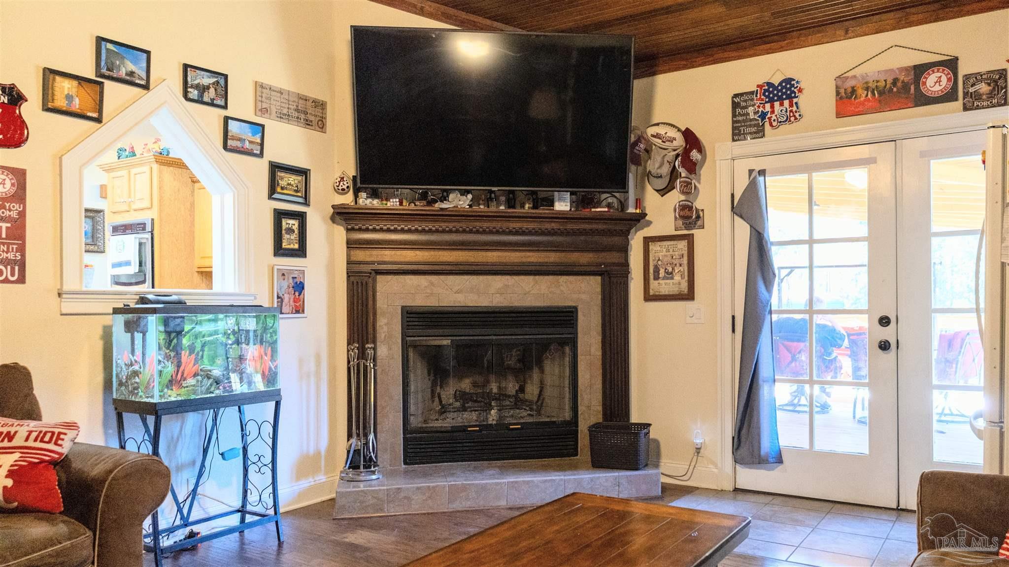 1700 Prospect Road Coffeeville, AL 36524 - Photo 5 of 71 a living room with fireplace furniture and a flat screen tv