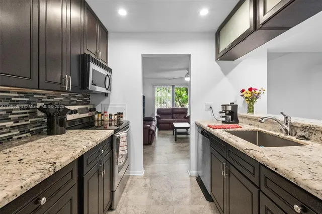 a kitchen with a sink stove and cabinets