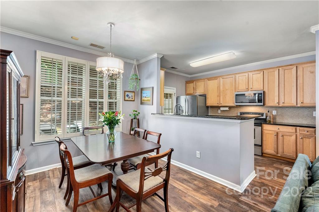 1921 Travertine Lane Fort Mill, SC 29708 - Photo 8 of 27 a kitchen with a table chairs refrigerator and microwave