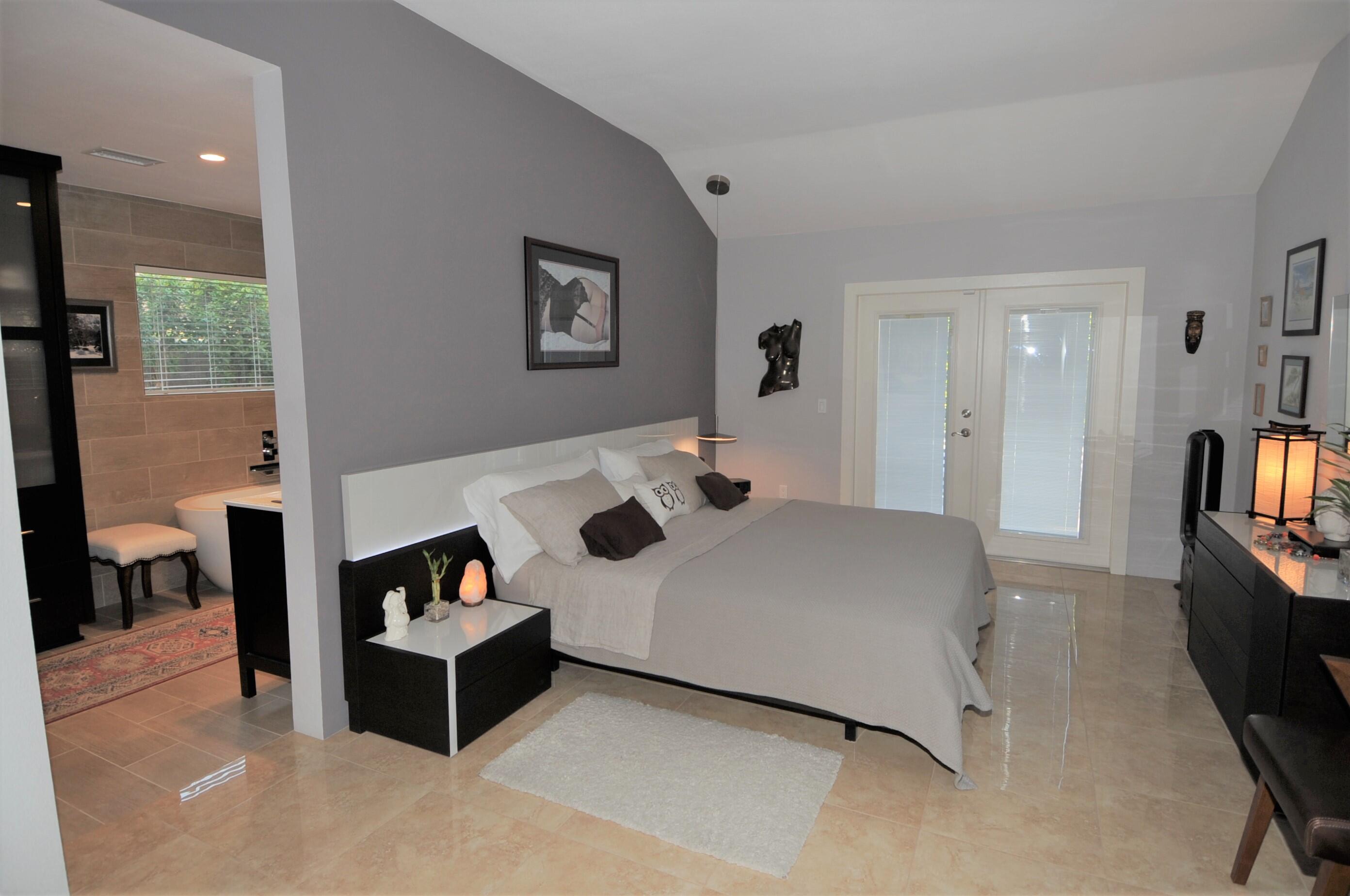 1490 East Racquet Club Road Palm Springs, CA 92262 - Photo 17 of 29 a bed room with a bed and a couch
