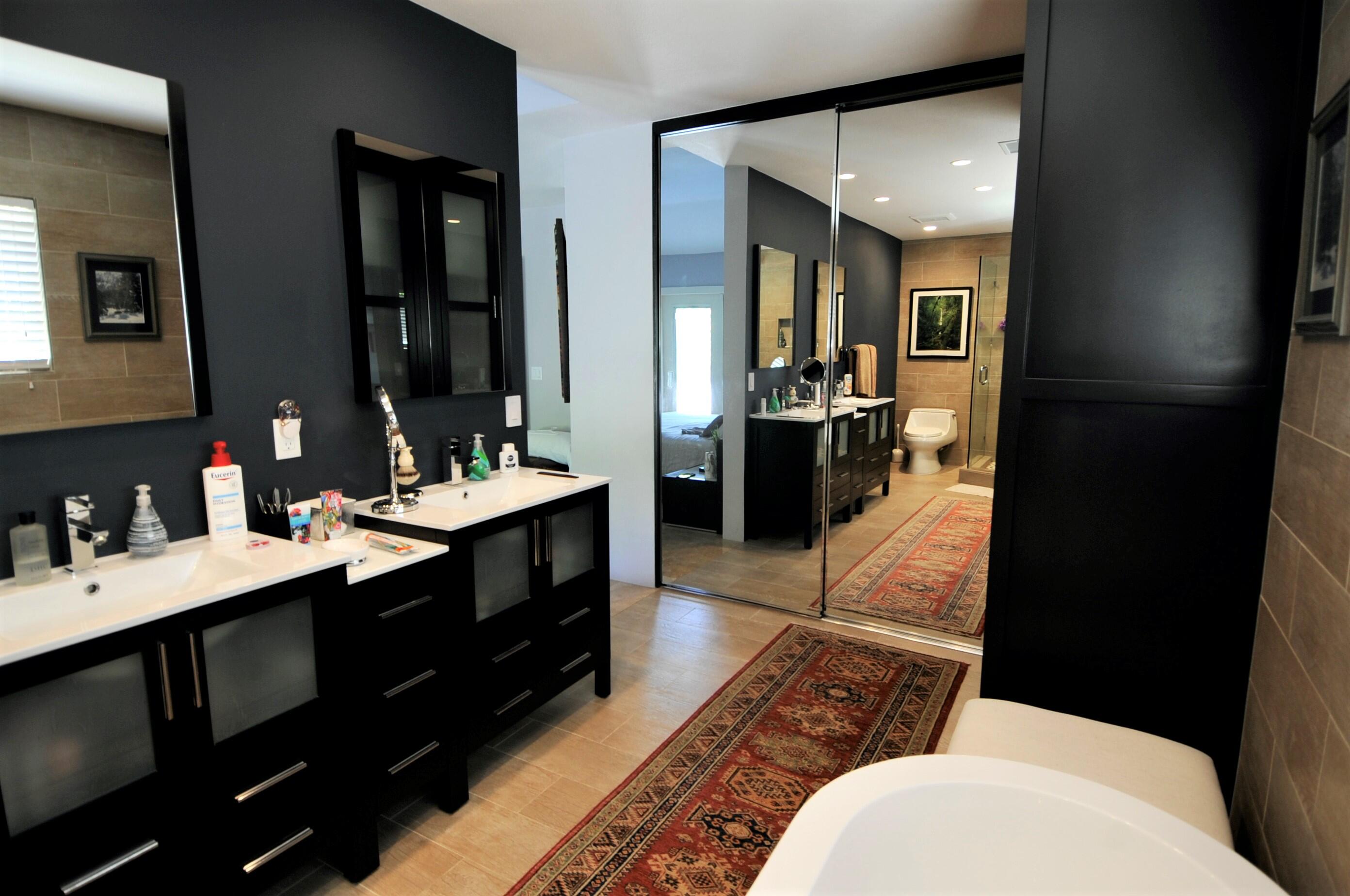 1490 East Racquet Club Road Palm Springs, CA 92262 - Photo 20 of 29 a bathroom with a double vanity sink toilet and mirror